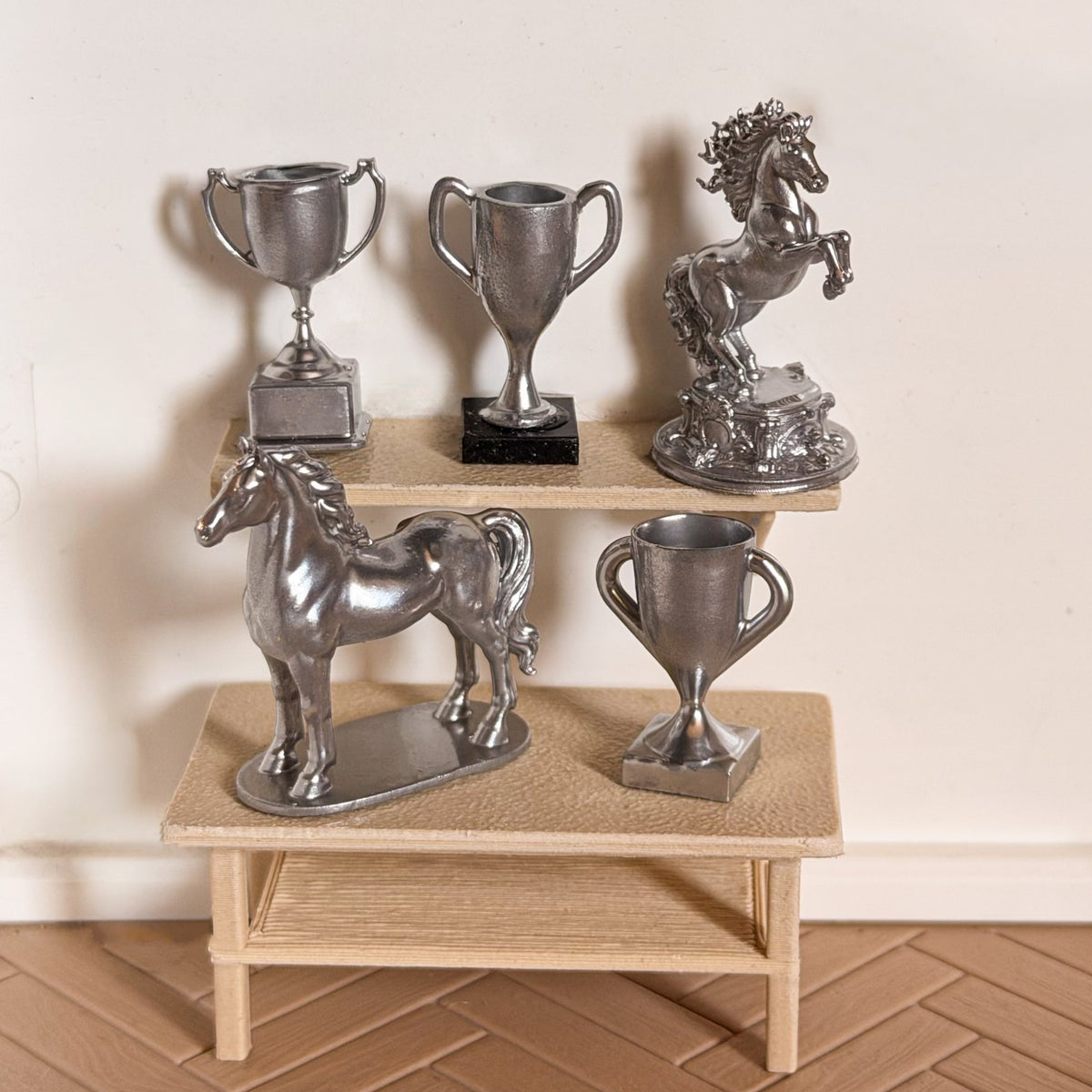 Silver horse trophy set: a rearing horse statue, a standing horse statue and three trophy cups on miniature shelves for Schleich model horses